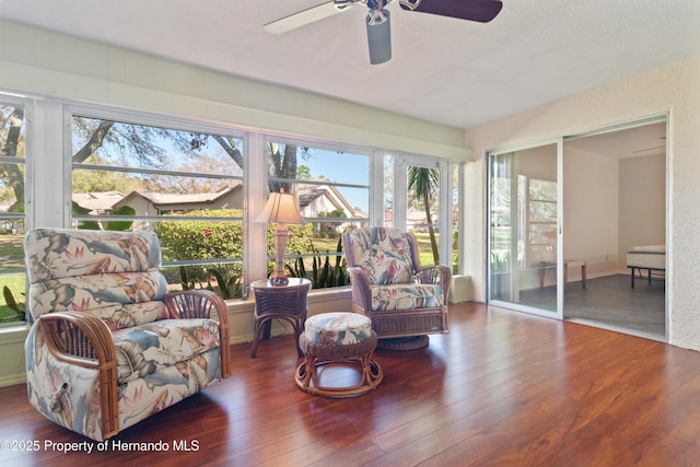 sunroom / solarium featuring ceiling fan