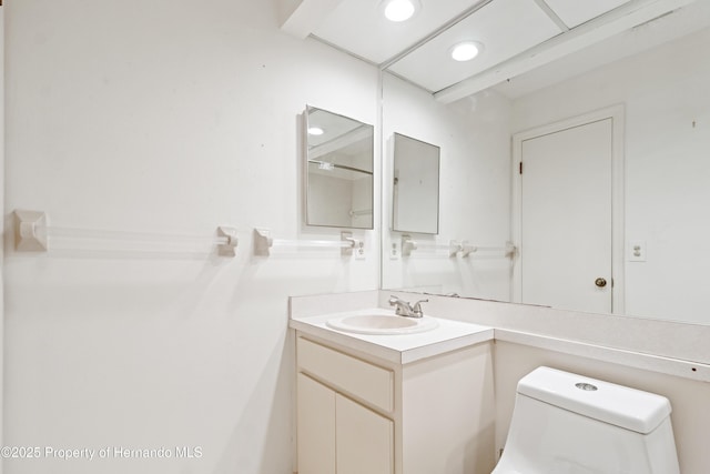 bathroom with recessed lighting, toilet, and vanity