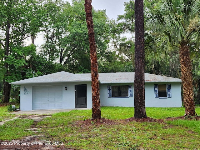 15218 Norris Bishop Loop, Brooksville, FL 34614 - ranch-style home featuring stucco siding, a front yard, and a garage