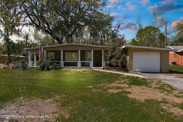 view of front of property with central air condition unit, an attached garage, dirt driveway, and a lawn