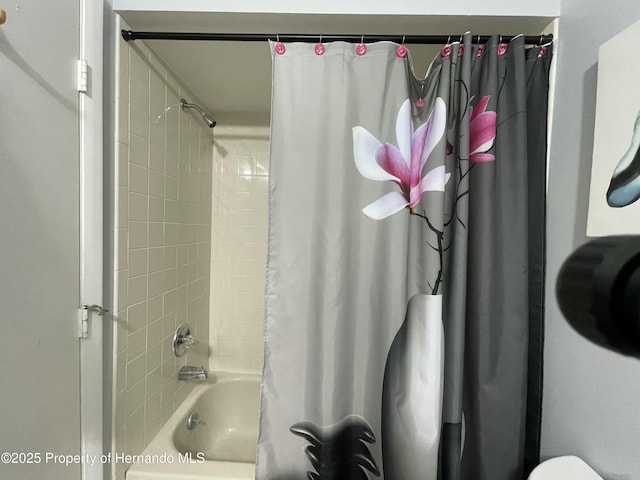 bathroom with shower / bath combination with curtain