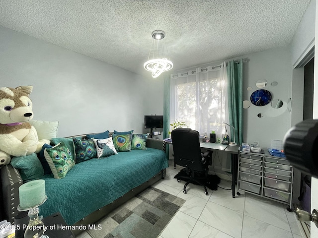 bedroom featuring a notable chandelier, marble finish floor, and a textured ceiling