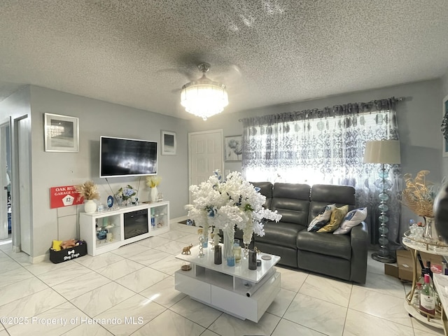 living area featuring marble finish floor and a textured ceiling