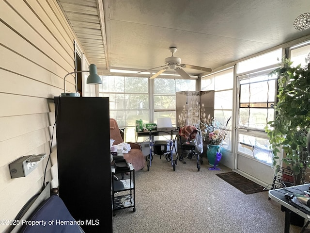 sunroom featuring a ceiling fan