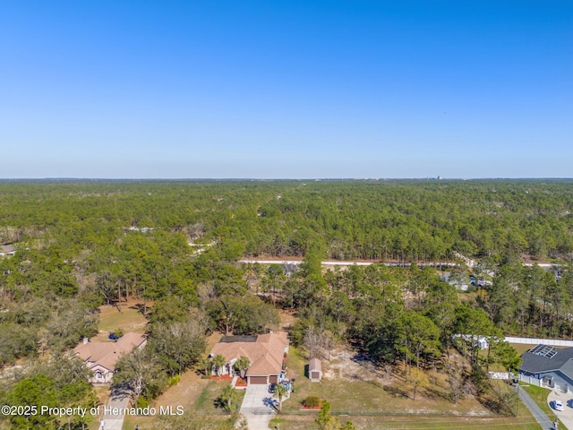 drone / aerial view featuring a view of trees