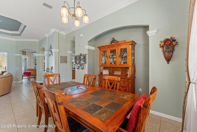 dining room with visible vents, ornamental molding, light tile patterned floors, decorative columns, and arched walkways