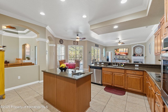 kitchen featuring stainless steel dishwasher, a ceiling fan, and open floor plan