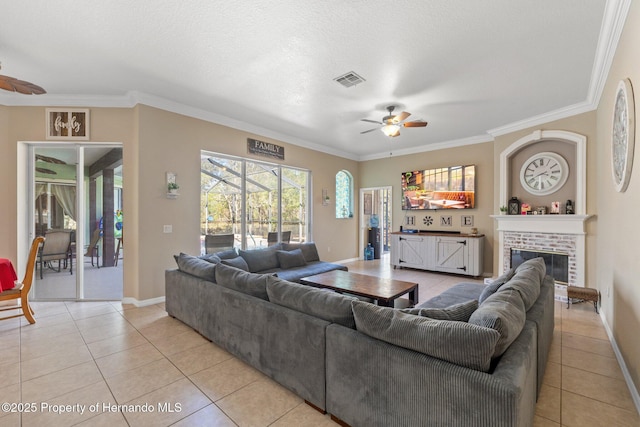 living room featuring light tile patterned floors, visible vents, crown molding, and ceiling fan