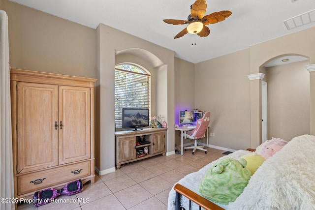 bedroom featuring light tile patterned floors, visible vents, arched walkways, and baseboards