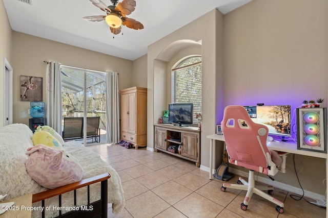 office space featuring visible vents, light tile patterned flooring, a ceiling fan, and baseboards