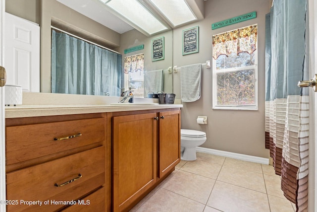 full bath with tile patterned flooring, toilet, vanity, and baseboards