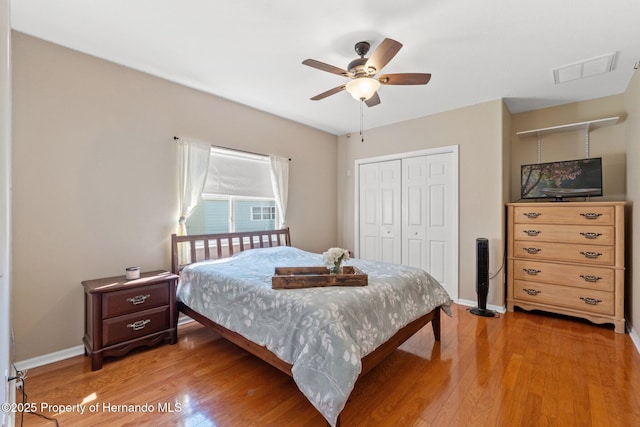 bedroom featuring a closet, baseboards, visible vents, and light wood-style flooring