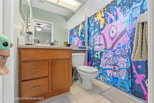 bathroom with toilet, a shower with curtain, tile patterned floors, vanity, and a ceiling fan