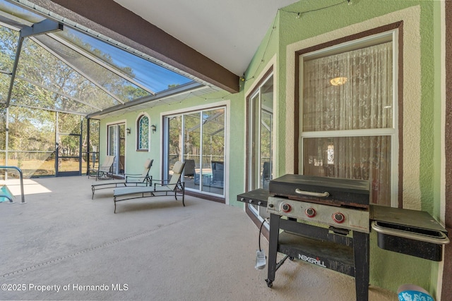 view of patio / terrace featuring grilling area and glass enclosure