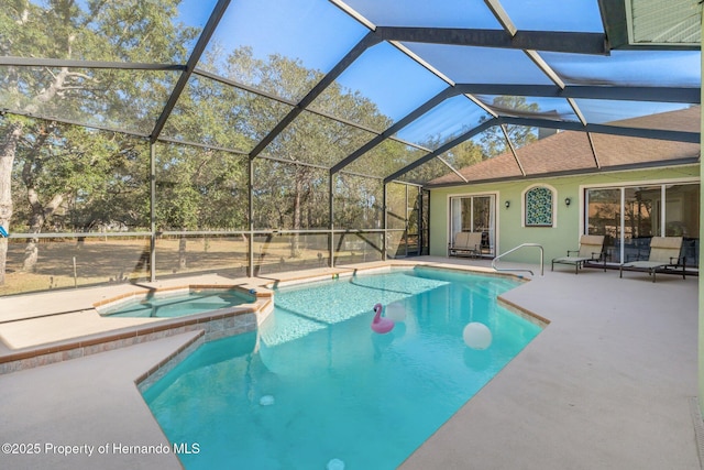 view of pool with a patio, a lanai, and a pool with connected hot tub