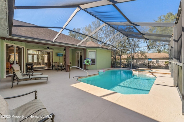 view of pool with a patio, a ceiling fan, a pool with connected hot tub, and a lanai