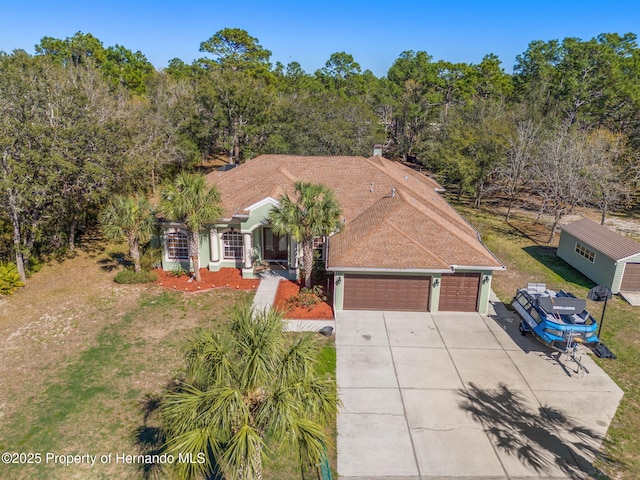 view of front facade with driveway, a front lawn, and an attached garage