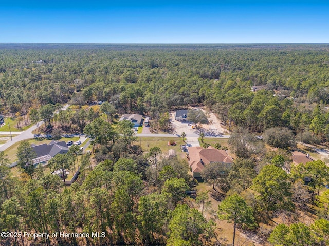 bird's eye view featuring a wooded view