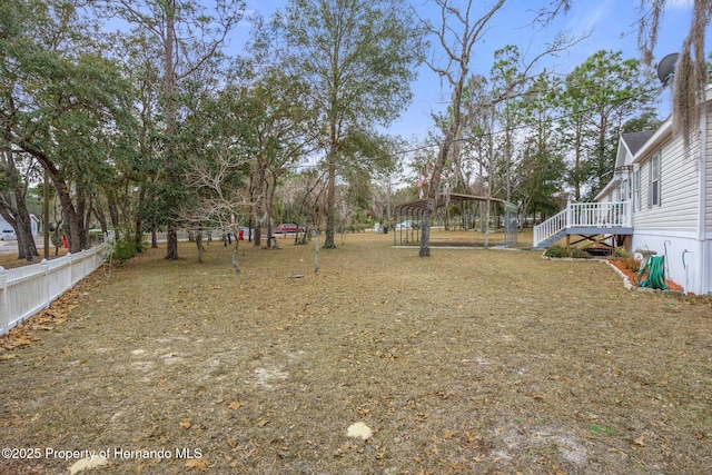 view of yard with a detached carport and fence
