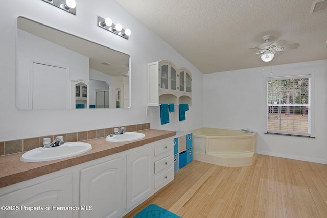 full bath featuring wood finished floors, a ceiling fan, visible vents, and a sink