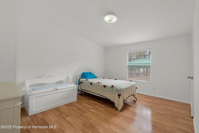 bedroom with baseboards and light wood-type flooring
