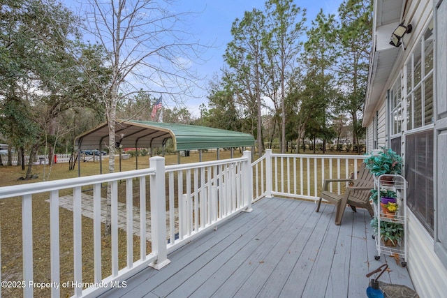 deck featuring a carport and fence