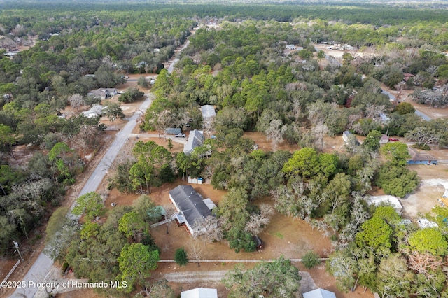 birds eye view of property featuring a view of trees