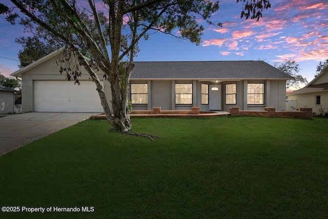 11080 Marquette St, Spring Hill, FL 34609 - view of front of property with a garage, driveway, and a lawn