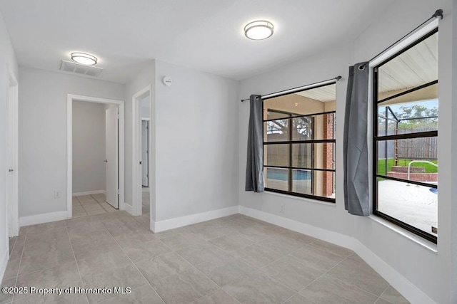 11080 Marquette St, Spring Hill, FL 34609 - unfurnished room featuring visible vents, baseboards, and light tile patterned floors