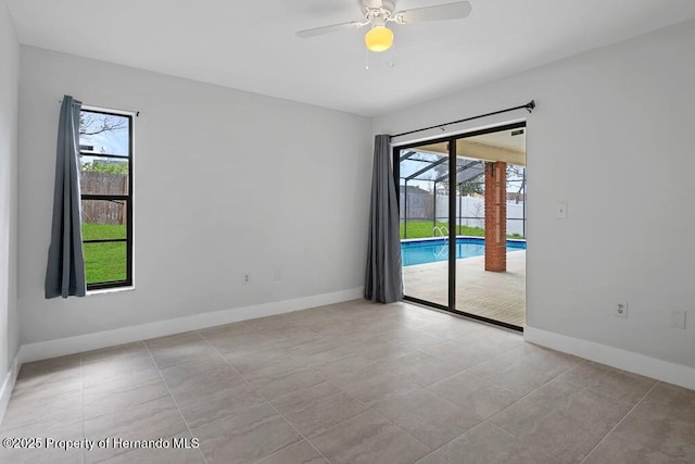 11080 Marquette St, Spring Hill, FL 34609 - empty room with light tile patterned flooring, ceiling fan, and baseboards