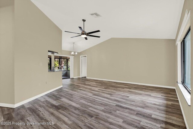 unfurnished living room with wood finished floors, visible vents, baseboards, and ceiling fan with notable chandelier