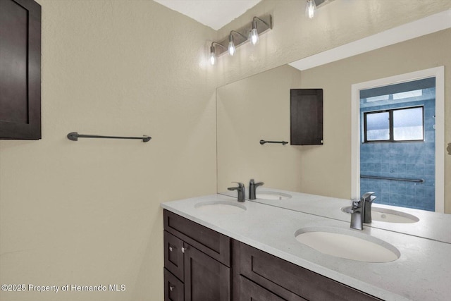 bathroom with a sink and double vanity
