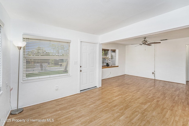 unfurnished room with ceiling fan and light wood-style floors