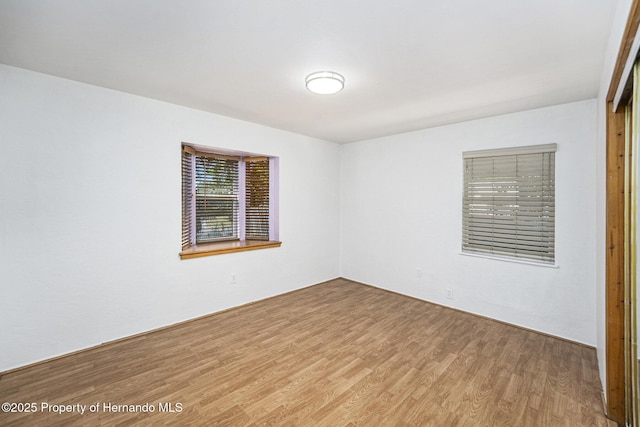 empty room with wood finished floors