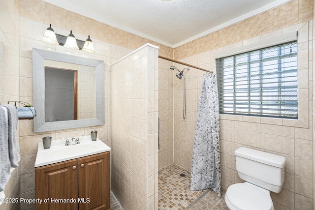 bathroom with a stall shower, tile walls, and a textured ceiling
