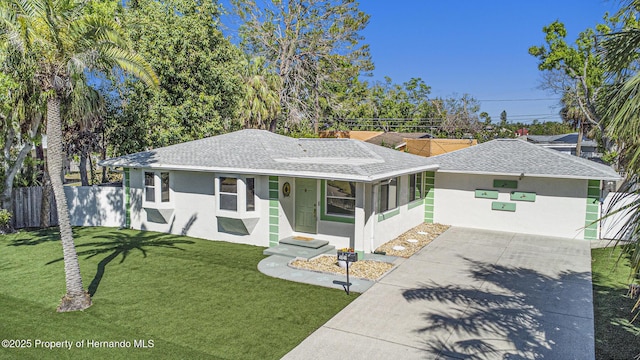 single story home featuring a front lawn, driveway, stucco siding, and fence