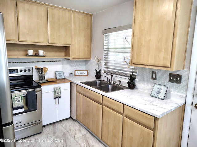 kitchen featuring light brown cabinets, marble finish floor, a sink, and appliances with stainless steel finishes