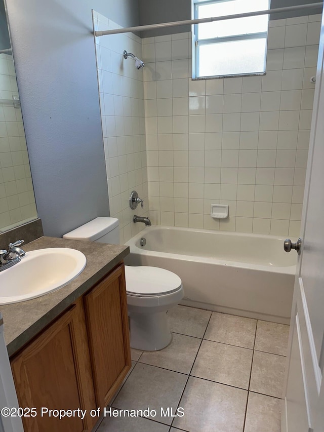 8480 Southern Charm Cir, Brooksville, FL 34613 - full bathroom featuring toilet, vanity, tile patterned flooring, and bathing tub / shower combination