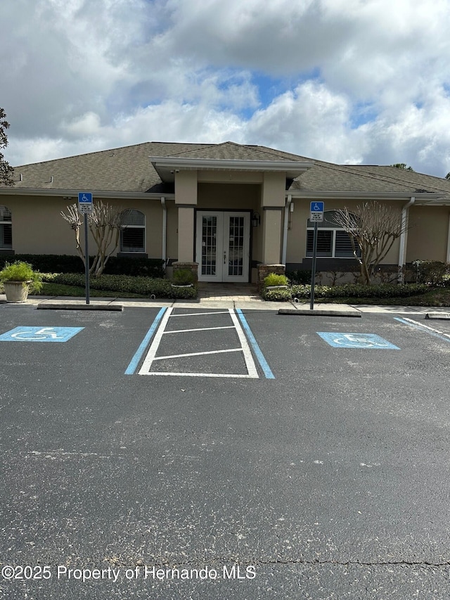 8480 Southern Charm Cir, Brooksville, FL 34613 - uncovered parking lot featuring french doors
