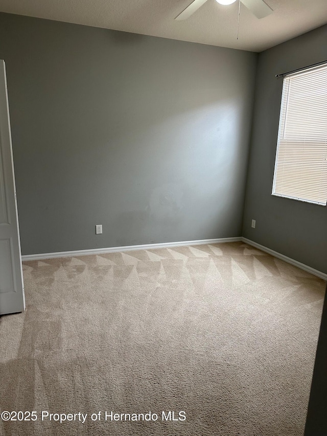 8480 Southern Charm Cir, Brooksville, FL 34613 - empty room featuring light carpet, baseboards, and ceiling fan