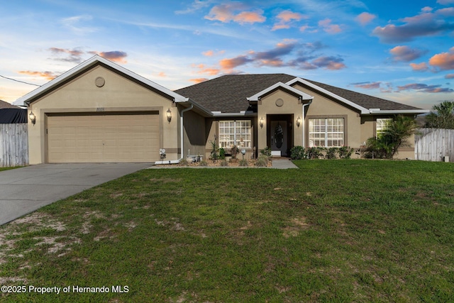 1018 Stratton Ave, Spring Hill, FL 34609 - single story home with stucco siding, fence, driveway, a garage, and a yard
