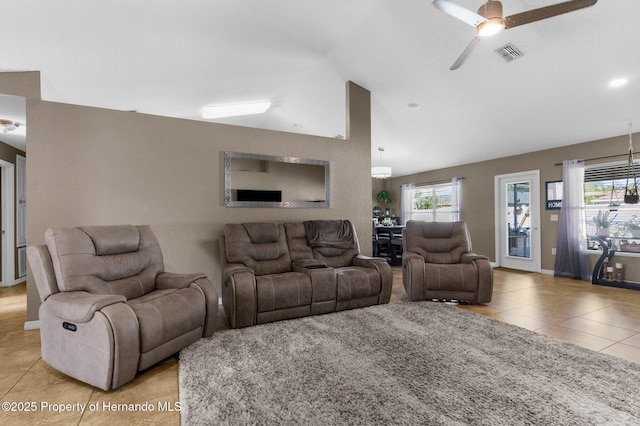 1018 Stratton Ave, Spring Hill, FL 34609 - living room featuring light tile patterned flooring, a healthy amount of sunlight, visible vents, and vaulted ceiling