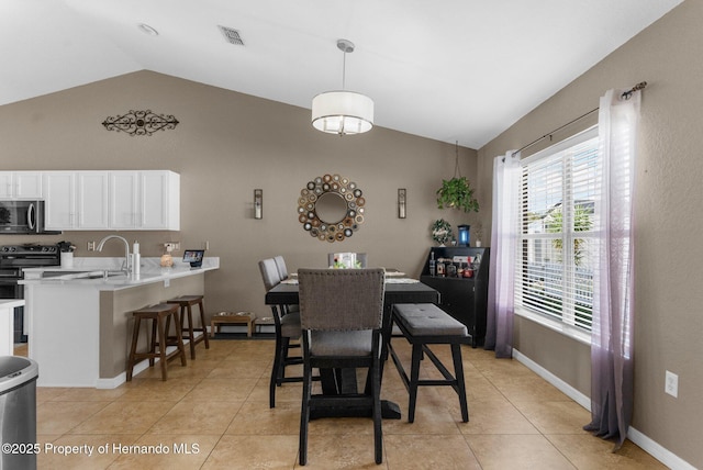 1018 Stratton Ave, Spring Hill, FL 34609 - dining area featuring light tile patterned floors, lofted ceiling, and visible vents