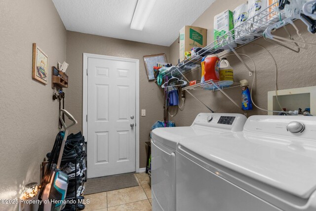 1018 Stratton Ave, Spring Hill, FL 34609 - laundry area with independent washer and dryer, light tile patterned floors, a textured wall, a textured ceiling, and laundry area