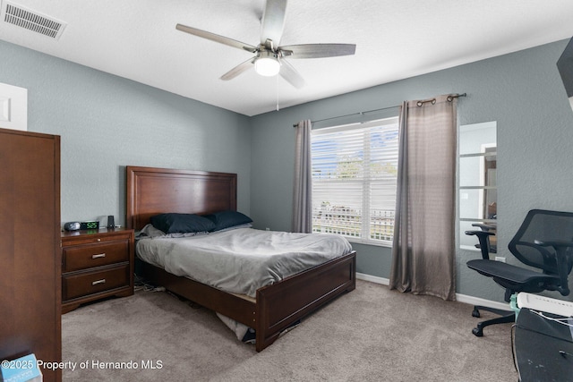 1018 Stratton Ave, Spring Hill, FL 34609 - bedroom featuring visible vents, baseboards, a ceiling fan, light carpet, and a textured wall