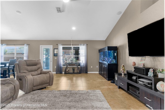 1018 Stratton Ave, Spring Hill, FL 34609 - living room with baseboards, lofted ceiling, visible vents, and light tile patterned floors