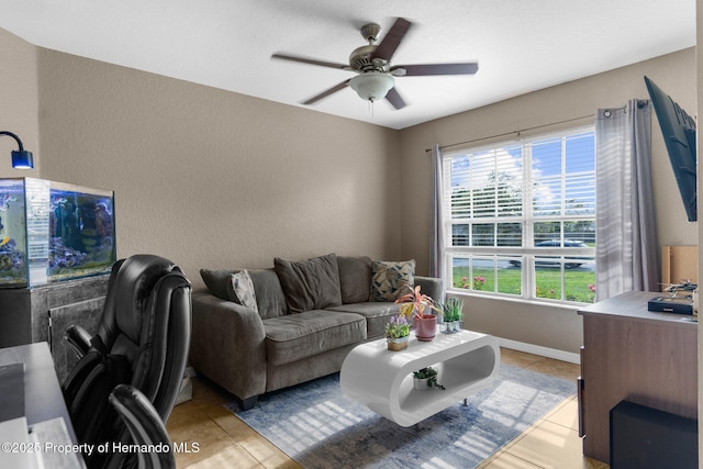 1018 Stratton Ave, Spring Hill, FL 34609 - living room with light tile patterned floors, baseboards, and a ceiling fan