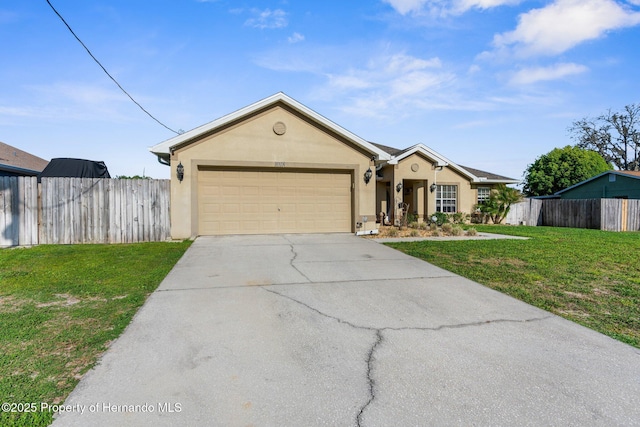 1018 Stratton Ave, Spring Hill, FL 34609 - single story home with driveway, fence, a garage, a front lawn, and stucco siding
