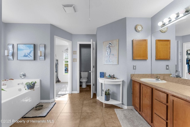 1018 Stratton Ave, Spring Hill, FL 34609 - bathroom featuring toilet, vanity, tile patterned flooring, a bath, and visible vents