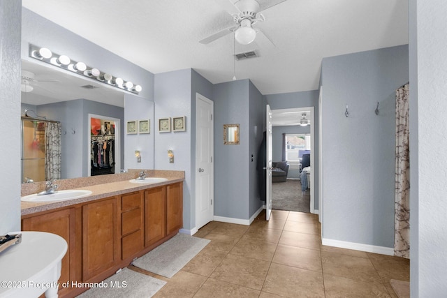 1018 Stratton Ave, Spring Hill, FL 34609 - bathroom featuring curtained shower, ceiling fan, a sink, and tile patterned flooring